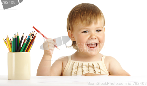 Image of Happy child play with color pencils and smile