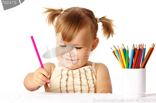Image of Happy child play with color pencils and smile
