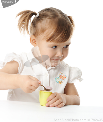 Image of Little girl eats yogurt