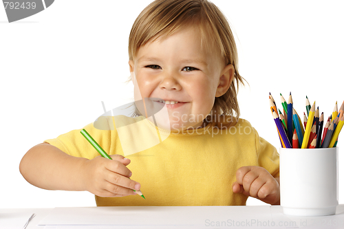 Image of Happy child play with crayons and smile