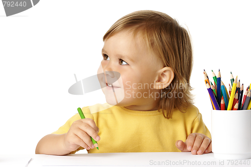 Image of Cute child draw with crayons and smile