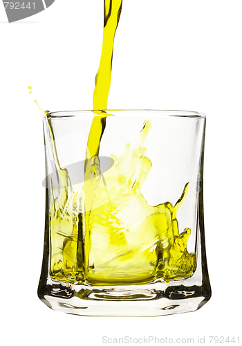 Image of Splash, yellow drink is being poured into glass