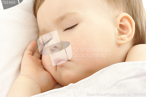 Image of Cute child sleep with hand under his cheek