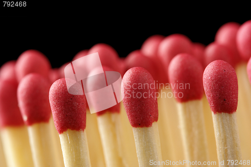 Image of Line of red matchsticks on black background