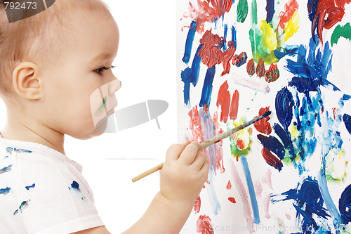Image of Little girl paint on a board