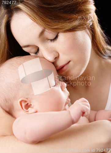 Image of Mother holds her dreaming child