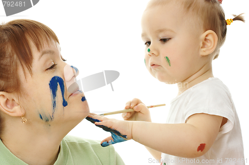 Image of Little girl paint on her mother