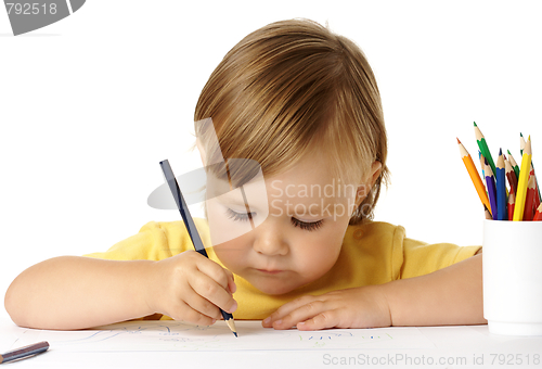 Image of Cute child focused on drawing