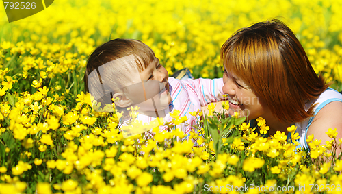 Image of Mother and her child play on meadow