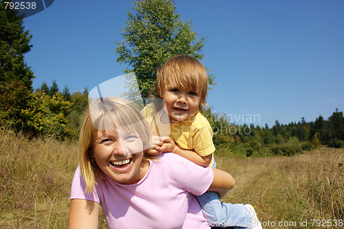 Image of Mother and child play outdoors