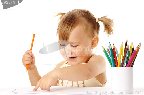 Image of Happy child points on her drawing and smile