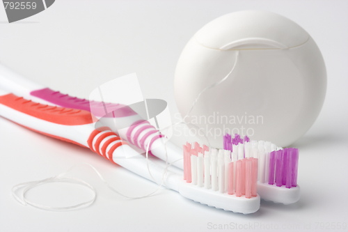 Image of Two toothbrushes and dental floss