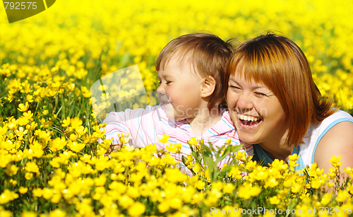 Image of Mother and child play on meadow
