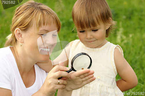 Image of Child with mother looking at snail
