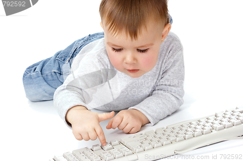 Image of Cute child typing on a keyboard