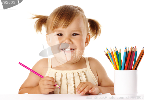Image of Happy child play with crayons and smile