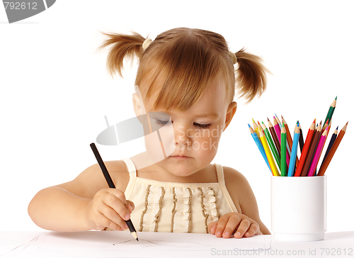 Image of Cute preschooler focused on drawing