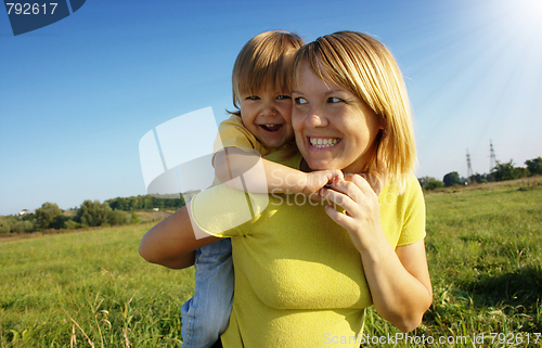 Image of Mother and child play outdoors