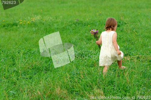 Image of Little girl walk on green field