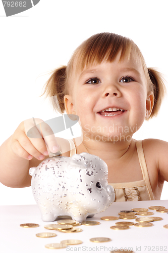 Image of Cute little girl with piggybank