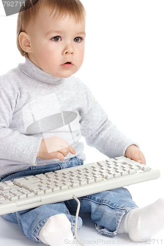 Image of Cute child typing on a keyboard