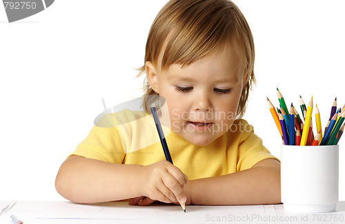Image of Cute preschooler focused on her drawing