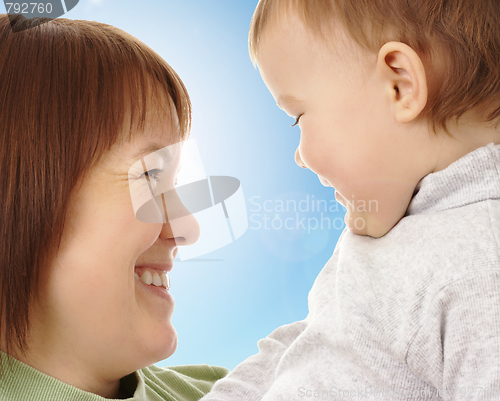 Image of Happy mother looking at her child