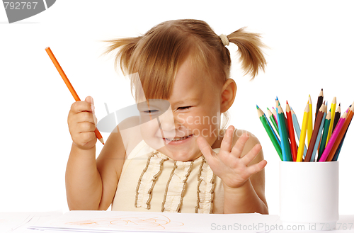 Image of Happy child play with color pencils and smile