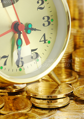 Image of Time is money - clock dial and golden coins