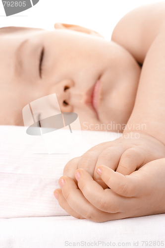 Image of Sleeping little child, clasping his hands together