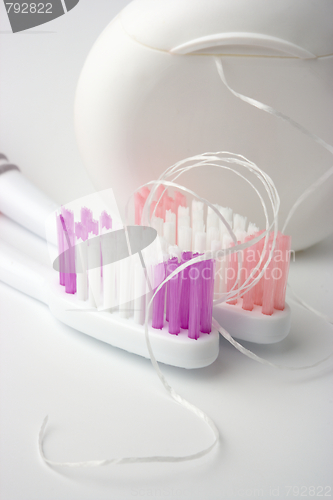 Image of Two toothbrushes and dental floss