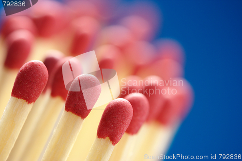 Image of Red matchsticks on blue background