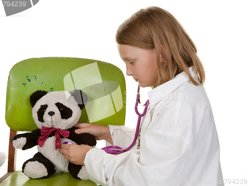 Image of girl playing doctor with her toys