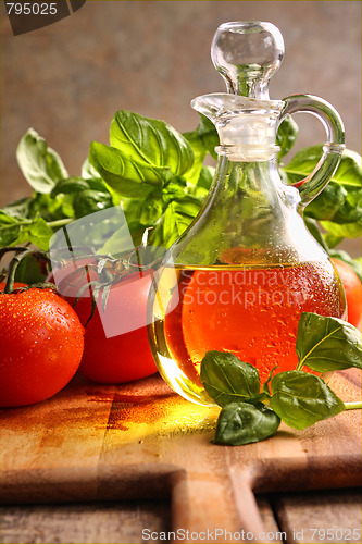 Image of Bottle of olive oil with vegetables