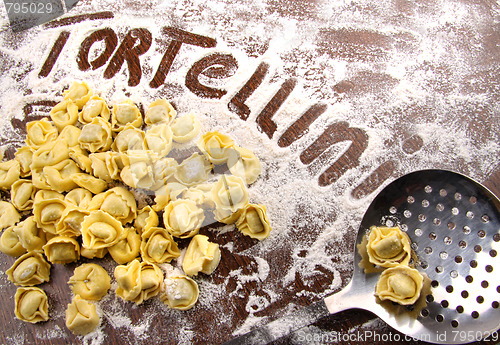 Image of Fresh, raw tortellini with flour