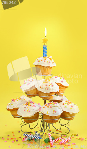 Image of Cupcakes with blue candle on yellow