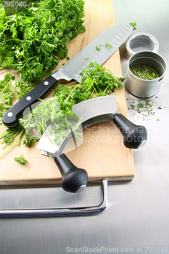 Image of Fresh chopped parsley with cutting board