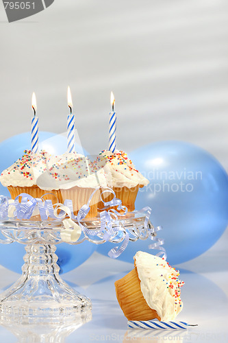 Image of Birthday cupcakes with blue candles