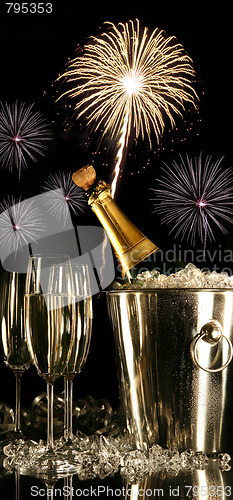 Image of Glasses of champagne with fireworks