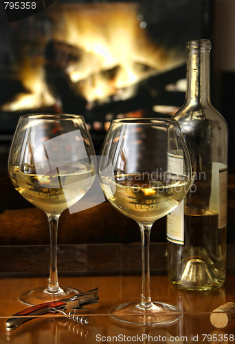 Image of White wine in front of a warm fire