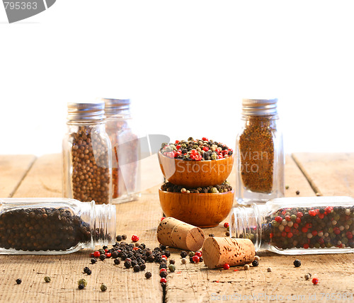 Image of Spice glass containers on old wood table