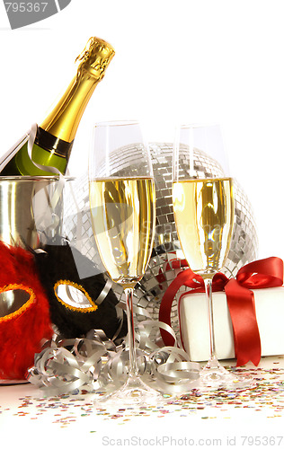 Image of Glasses of champagne with mask and gift