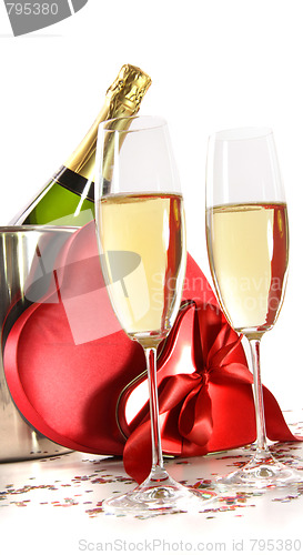 Image of Champagne glasses with valentine gifts on white