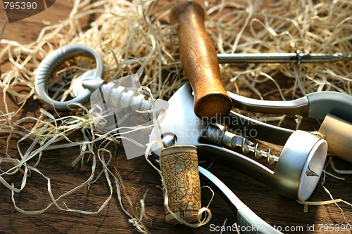 Image of Cork screws laying on oak table 