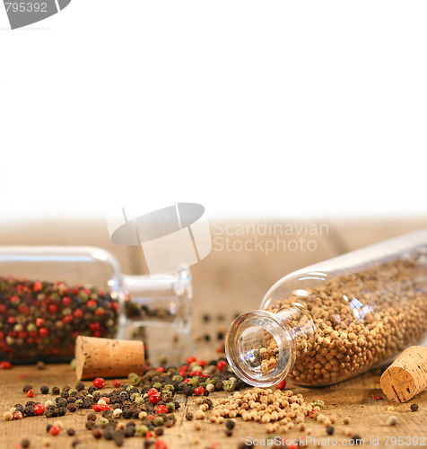 Image of Bottles of spices on rustic table 