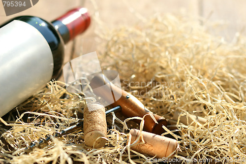 Image of Bottle of red wine with corkscrew 