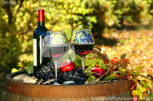 Image of Glasses of red wine on old barrel