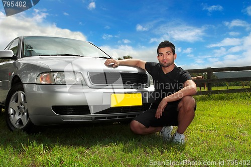 Image of Man beside car in afternoon sun