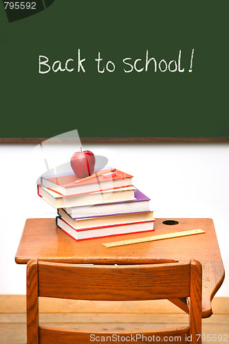 Image of Old school desk with a stack of books