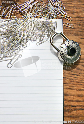 Image of White pad with paper clips, school lock 